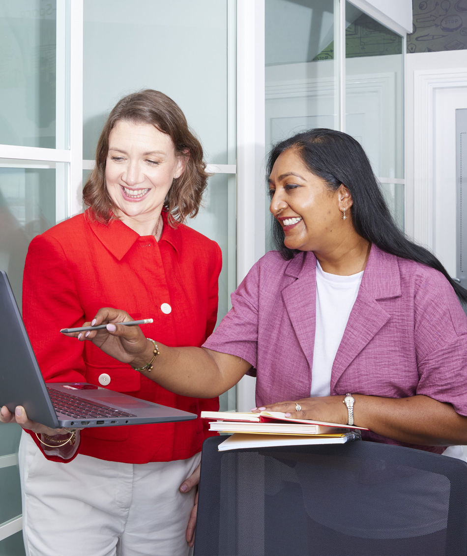 Two business consultants discussing strategy with a laptop during an executive coaching session